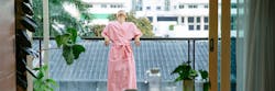 Woman standing on balcony and enjoying morning time