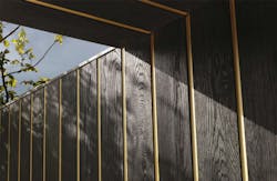Gold metallic band between vertical siding boards