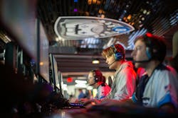 Gamers playing games in esports arena