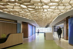 Confidential Technology Client Headquarters, Chicago, Ill. The west-facing Boulevard pre-function anchors the space, highlighting the fluid architecture and bespoke ceiling reminiscent of tree cover and natural materials