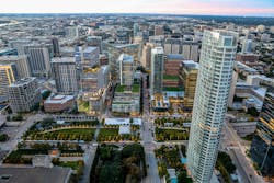 Pictured: Bank of America Tower at Parkside, Dallas, Texas. The Bank of America Tower at Parkside&rsquo;s 30 stories feature a striking sculptural design, where transparent glass and landscaped terraces blend seamlessly with the park below, creating a visually dynamic experience
