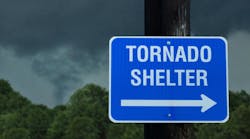 Tornado shelter sign with a small funnel cloud on background - concept for immediate danger in severe weather and seeking for shelter