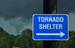 Tornado shelter sign with a small funnel cloud on background - concept for immediate danger in severe weather and seeking for shelter Tornado shelter sign with a small funnel cloud on background - concept for immediate danger in severe weather and seeking for shelter