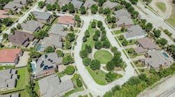 Colorful concrete roof tiles row of large two story suburban single-family houses swimming pools in upscale residential neighborhood Coppell, suburbs Dallas Fort Worth, well-trimmed landscape. USA