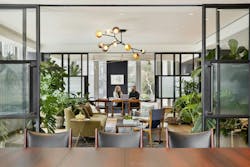Two people sitting in modern biophilic office room