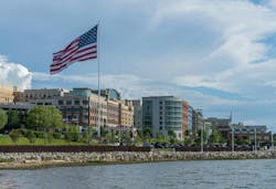 USA Flag flying at National Harbor in Maryland near Washington DC. National Harbor, MD - 24 June 2023: Skyline of National Harbor with large USA Flag flying near Washington DC USA Flag flying at National Harbor in Maryland near Washington DC. National Harbor, MD - 24 June 2023: Skyline of National Harbor with large USA Flag flying near Washington DC