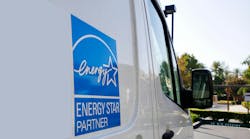 Energy Star sign. The Energy Star logo on the side of a machine repair truck in a parking lot.