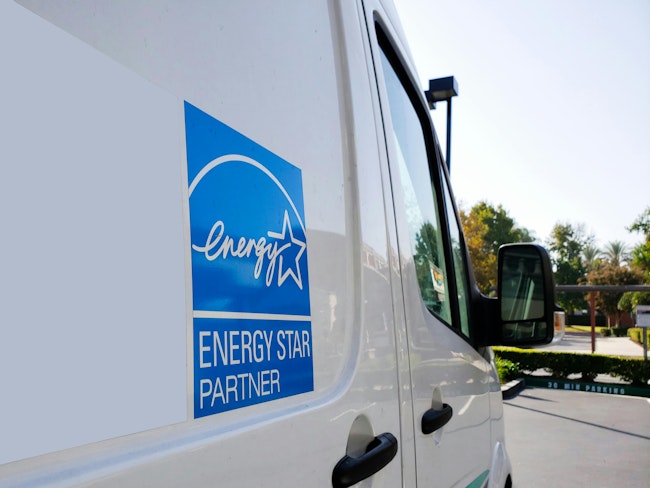 Energy Star sign. The Energy Star logo on the side of a machine repair truck in a parking lot.
