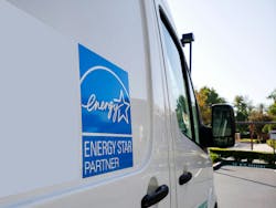 Energy Star sign. The Energy Star logo on the side of a machine repair truck in a parking lot.