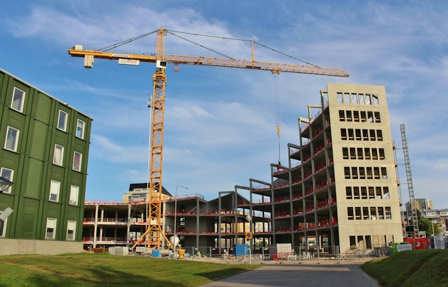 Construction site. A construction crane in the work to construct a new building.