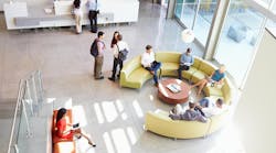 Reception Area Of Modern Office Building With People Overhead Shot